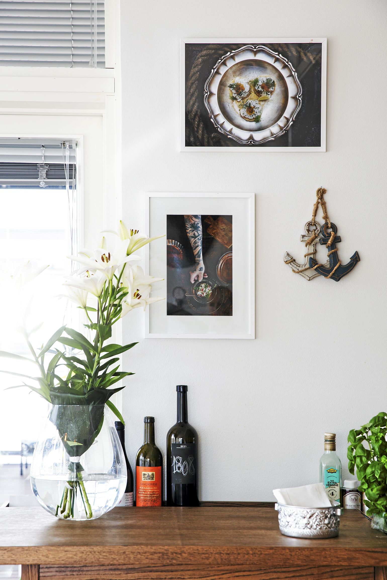 SAAREKKEEN ON NIKKAROINUT Tebian-merkin isä Teppo Lakaniemi. Miehen käsialaa on myös Björckien keittiön suurikokoinen ruokapöytä ja kirjahyllyt.Seinällä roikkuvat ankkurit Tomi osti Australiasta,ja valokuvataulut ovat lahjoja Huippukokin kotiruokaa -kirjojen kustantajalta.