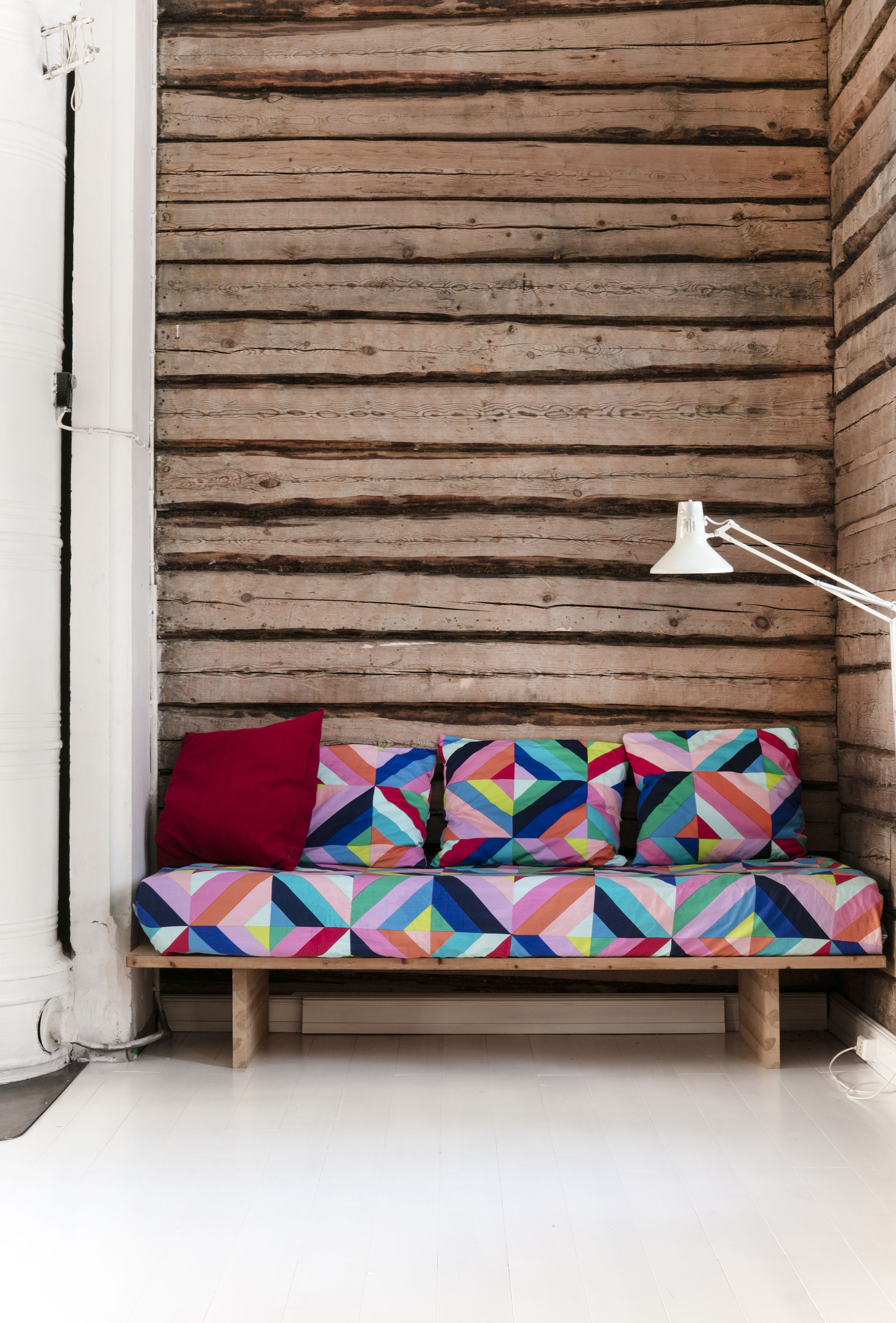 Olohuoneen sohva on verhoiltu Maija Louekarin Marimekolle suunnittelemalla Tilkkutäkki-kankaalla.